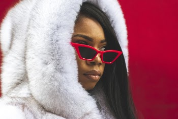 Woman in White Fur Coat Wearing Sunglasses