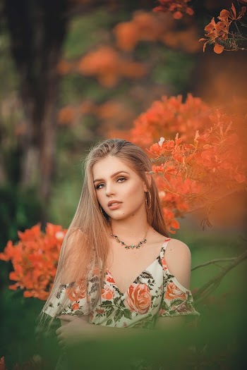 Woman in White, Green, and Orange Floral Off-shoulder Top