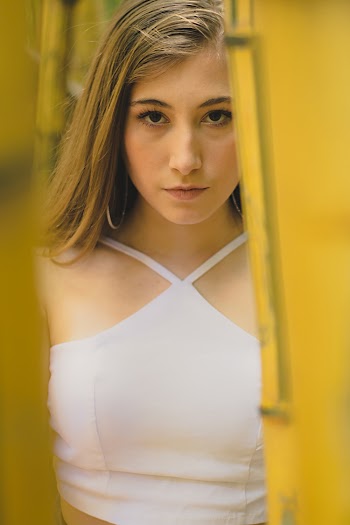 Woman in White Halter Top Hiding Behind Bamboos