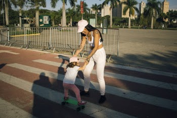 Woman in White Holding Child on Park Stairs