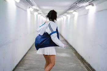 Woman in White Jacket at the Hallway