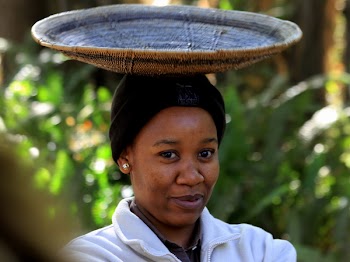 Woman in White Jacket Wearing Black Knit Hat