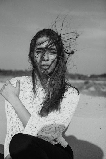 Woman in White Knit Sweater Sitting