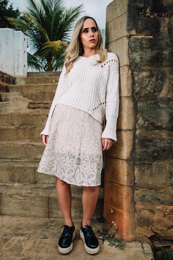Woman in White Knitted Top Leaning of Wall