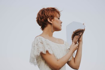 Woman in White Lace Off-shoulder Top Holding a Mirror