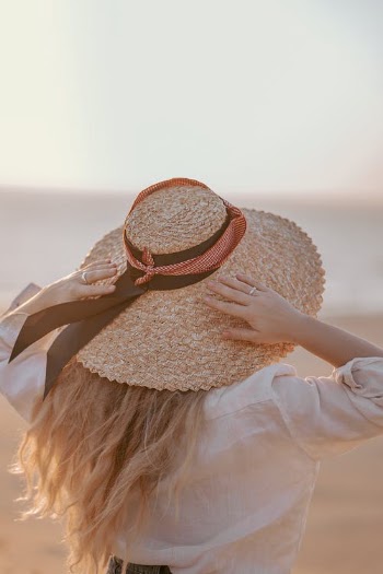 Woman in White Long Sleeve Shirt Wearing Brown Sun Hat · Free Stock Photo