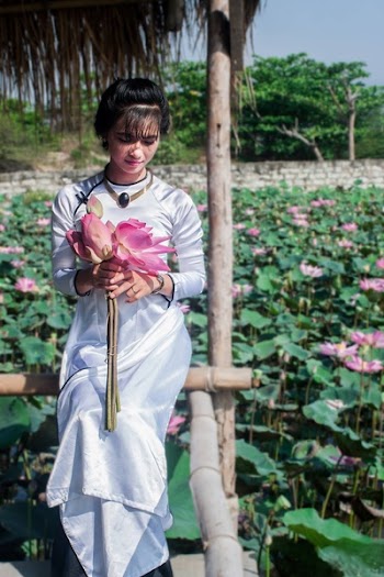 Woman in White Long-sleeved Dress Holding Pink Flower