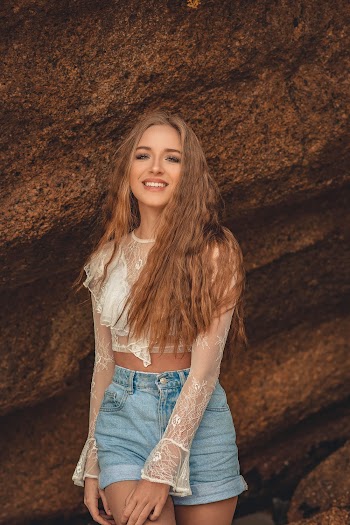 Woman in White Long-sleeved Shirt and Blue Denim Shorts