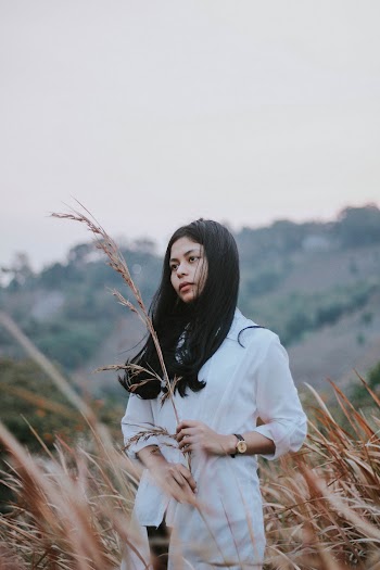 Woman in White Long-sleeved Shirt Holding Wheat
