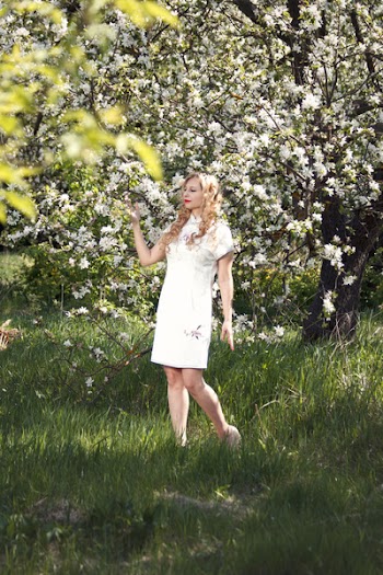 Woman in White Mini Dress Standing on Green Grass Field