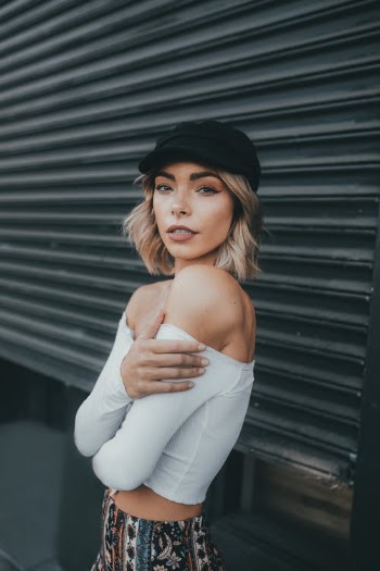 Woman in White Off Shoulder Crop Top Shirt and Black Cap · Free Stock Photo
