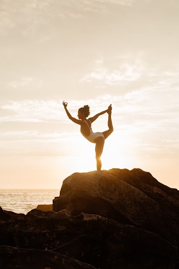 Woman in White One-piece Swimsuit Doing Yoga