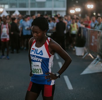 Woman in White,red,and Blue Fila Sports Tank Top