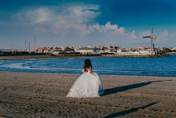 Woman in White Sheer Lace Dress Standing Near Body of Water