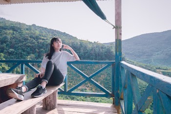 Woman in White Shirt Sitting on Bench Beside over Look Mountain