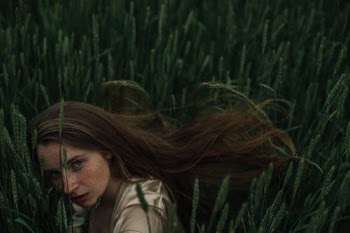 Woman in White Shirt Standing on Green Grass Field · Free Stock Photo