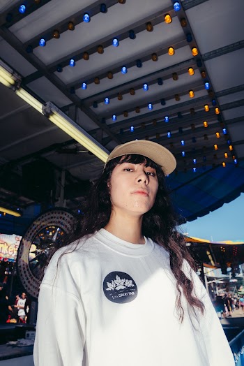 Woman in White Shirt Standing Under Canopy