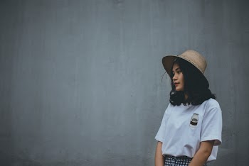 Woman in White Shirt Wearing Brown Hat