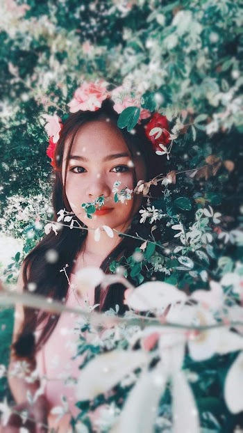 Woman in White Shirt With Red Flower on Her Head