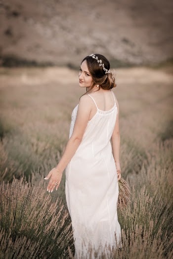Woman in White Sleeveless Dress Standing in Field