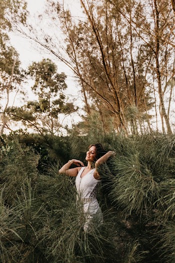 Woman in White Sleeveless Dress Standing Outdoors