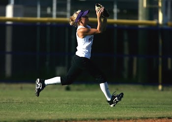Woman in White Sleeveless Shirt Playing Softball
