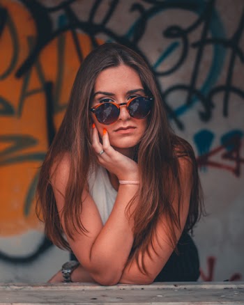 Woman in White Sleeveless Top With Sunglasses