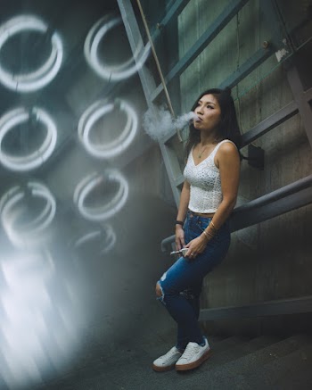 Woman In White Sleeveless V-neck Shirt Smoking 