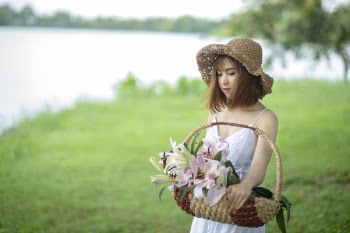 Woman in White Spaghetti Dress Holding Basket