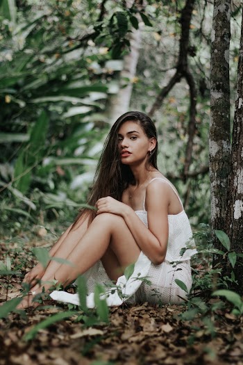 Woman in White Spaghetti Strap Top Sitting on Ground Near Tree
