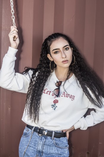Woman in White Sweat Shirt and Blue Denim Jeans