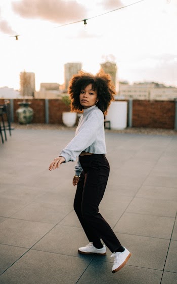 Woman in White Sweater and Black Jeans