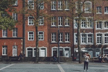 woman in white sweatshirt using camera