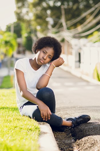 Woman in White T-shirt Sitting on Grass
