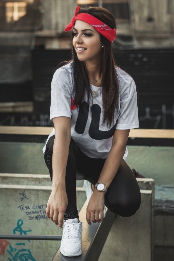 Woman in White T-shirt Squatting on Gray Metal Bar