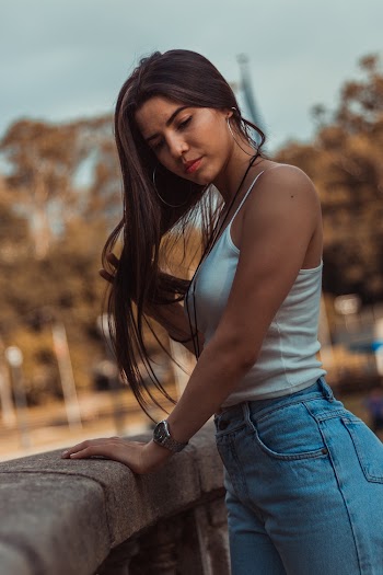 Woman In White Tank Top And Blue Denim Bottoms 