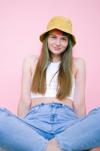 Woman in White Tank Top and Blue Denim Bottoms