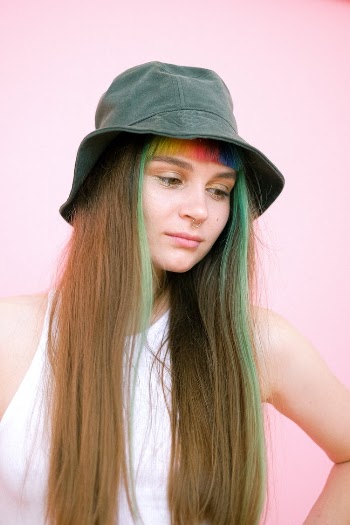 Woman in White Tank Top Wearing Gray Fedora Hat