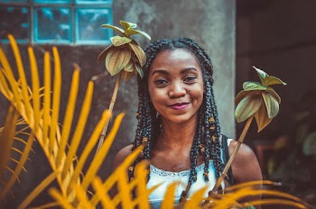 Woman in White Tank Top With Braided Hair