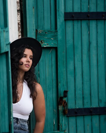 Woman in White Tank Tops and Blue Jeans