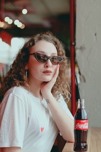 Woman In White Top Near Coca-cola Bottle