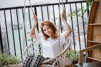 Woman in White Top Riding Swing Chair