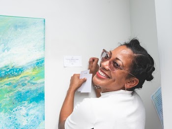 Woman in White Top Smiling Indoors