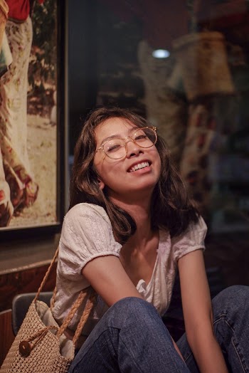 Woman in White Top Wearing Eye wear