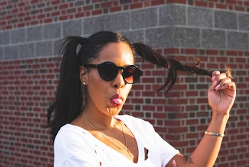 Woman in White Top With Tongue Out