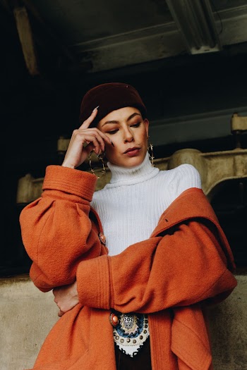 Woman In White Turtleneck Shirt And Orange Coat