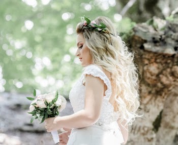 Woman in White Wedding Dress Holding White Rose Bouquet