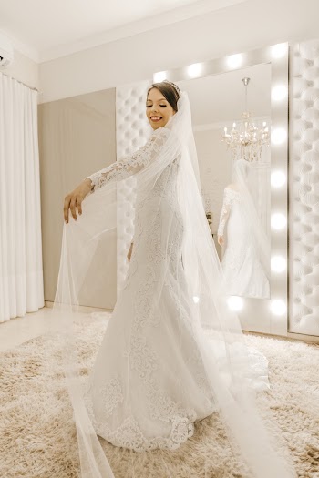 Woman in white Wedding Dress Standing in front of Vanity Mirror