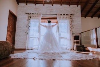Woman in White Wedding Gown by the Window