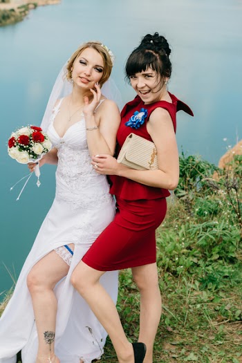 Woman in White Wedding Gown Holding Flowers Bouquet